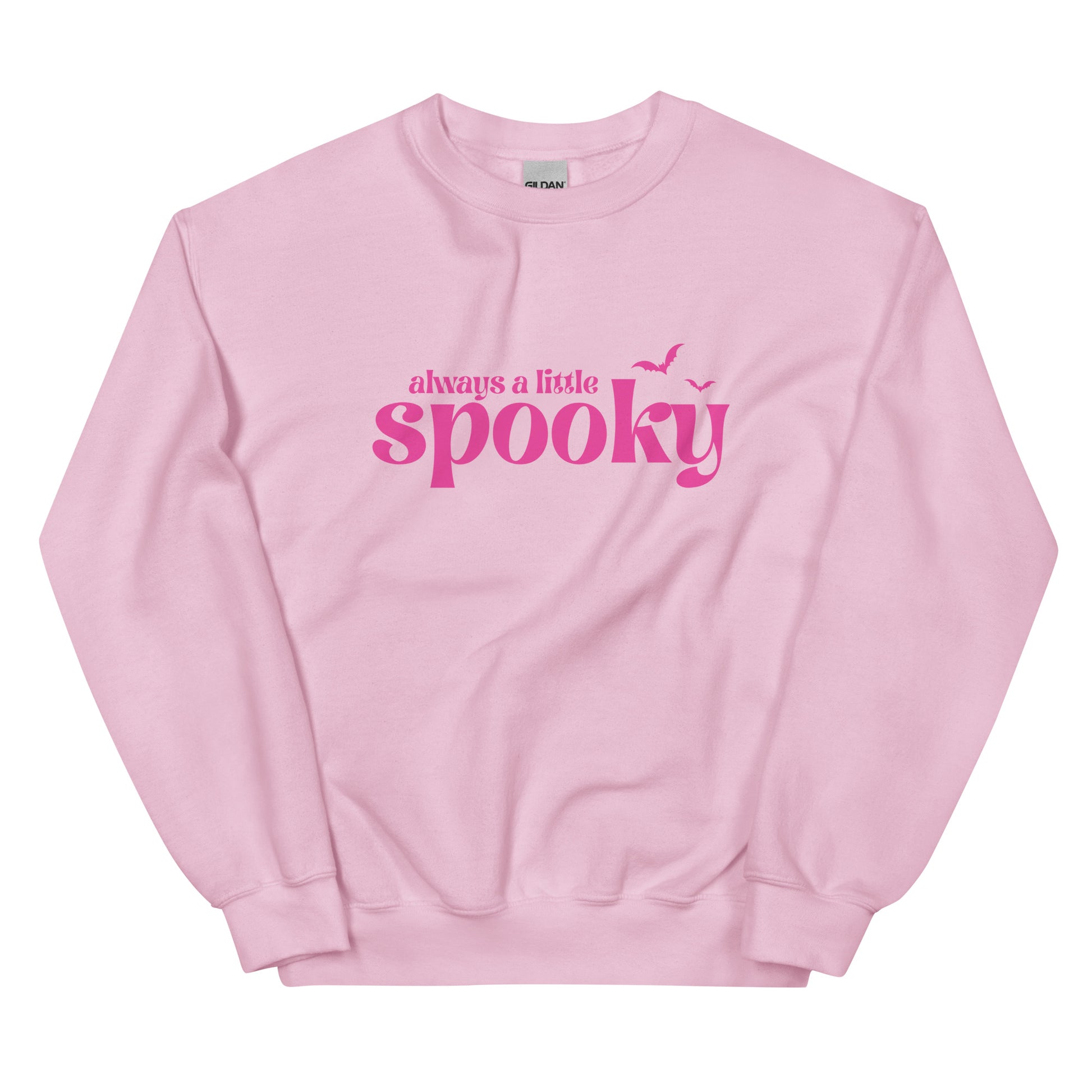 A pink Halloween crewneck sweatshirt that says "always a little spooky" in a trendy, bright pink font