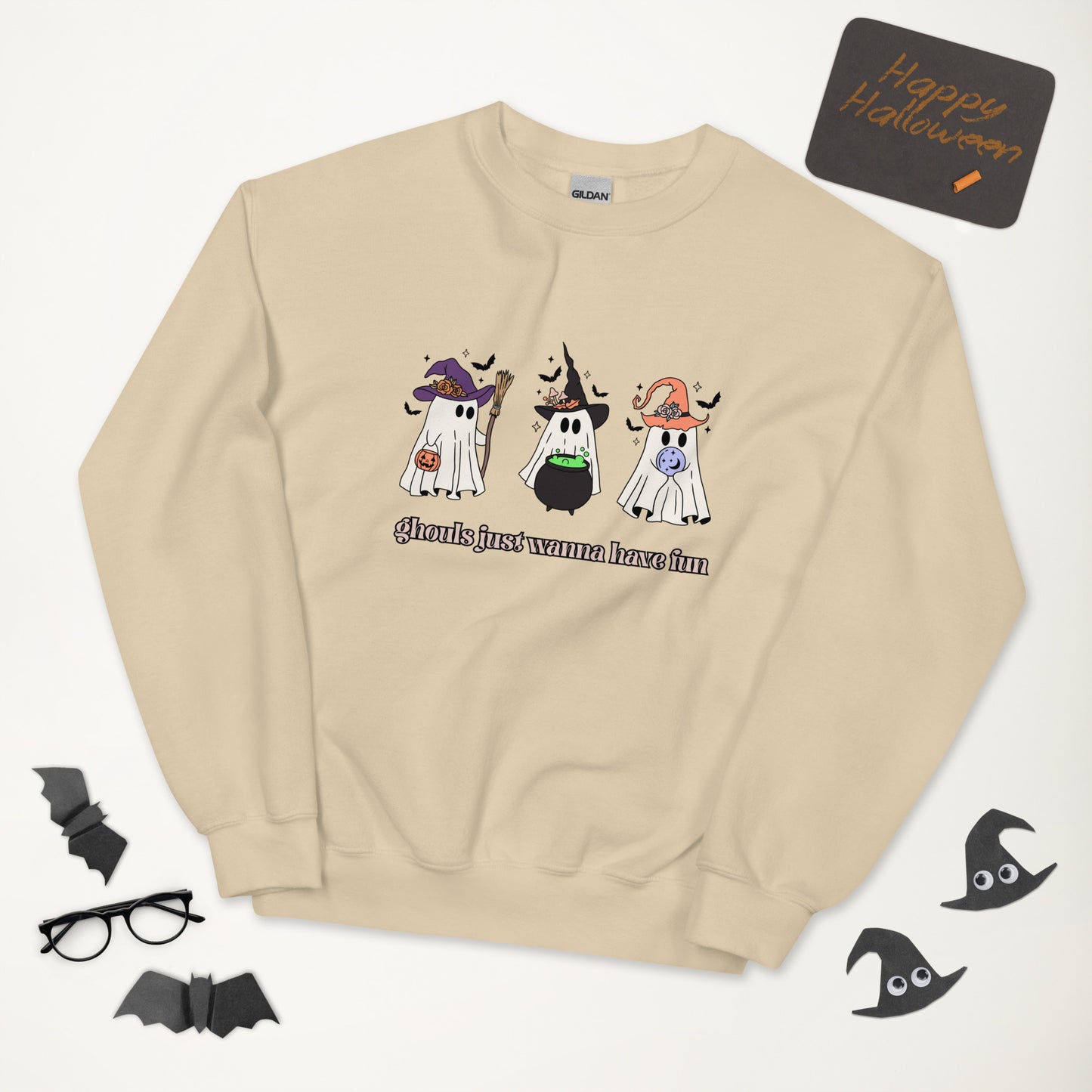 A tan Halloween crewneck sweatshirt, featuring three adorable ghosts all dolled up in costumes, with the phrase "ghouls just wanna have fun" underneath