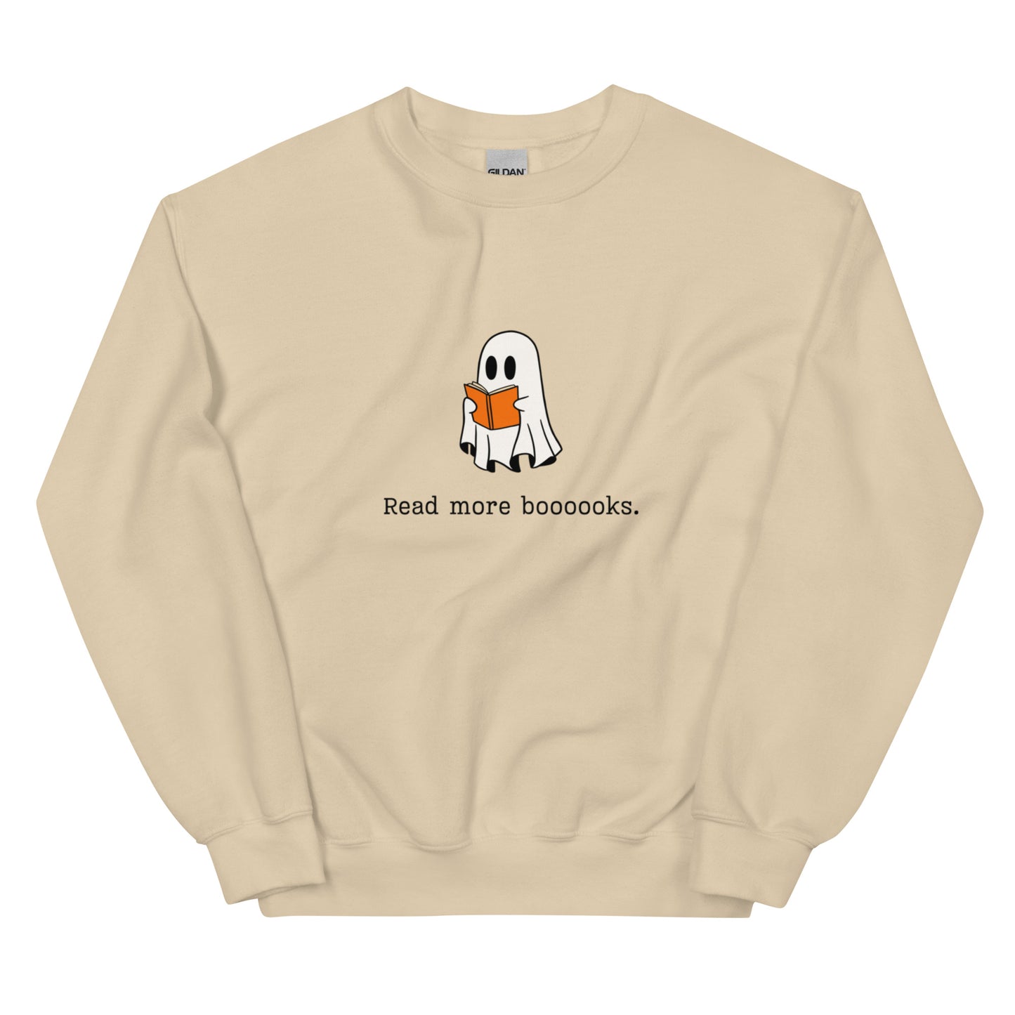 A tan Halloween crewneck sweatshirt featuring a ghost reading a book, with the phrase "Read more boooooks" underneath