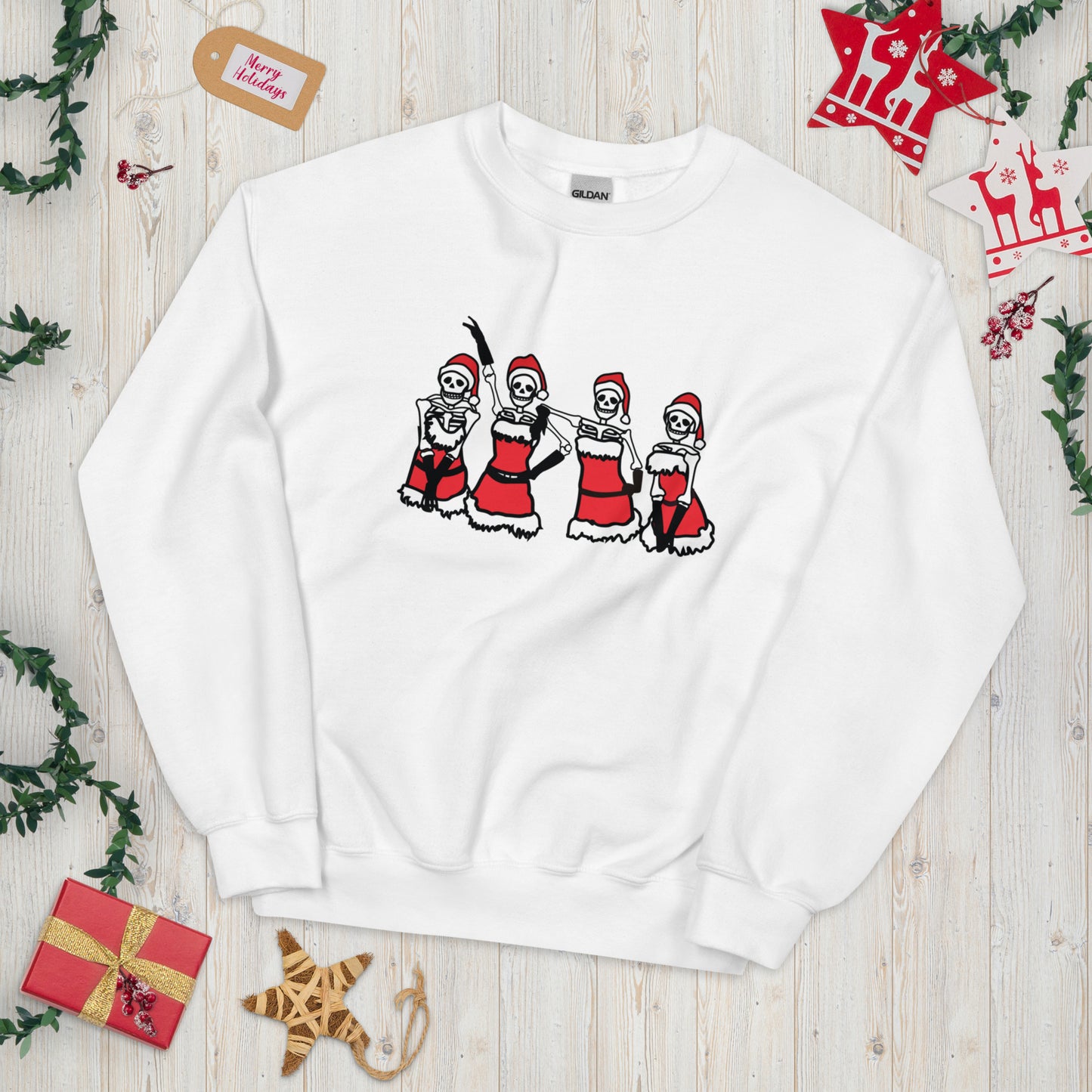 A white crewneck sweatshirt with a Mean Girls inspired lineup of skeletons wearing the Santa outfits from the Christmas talent show