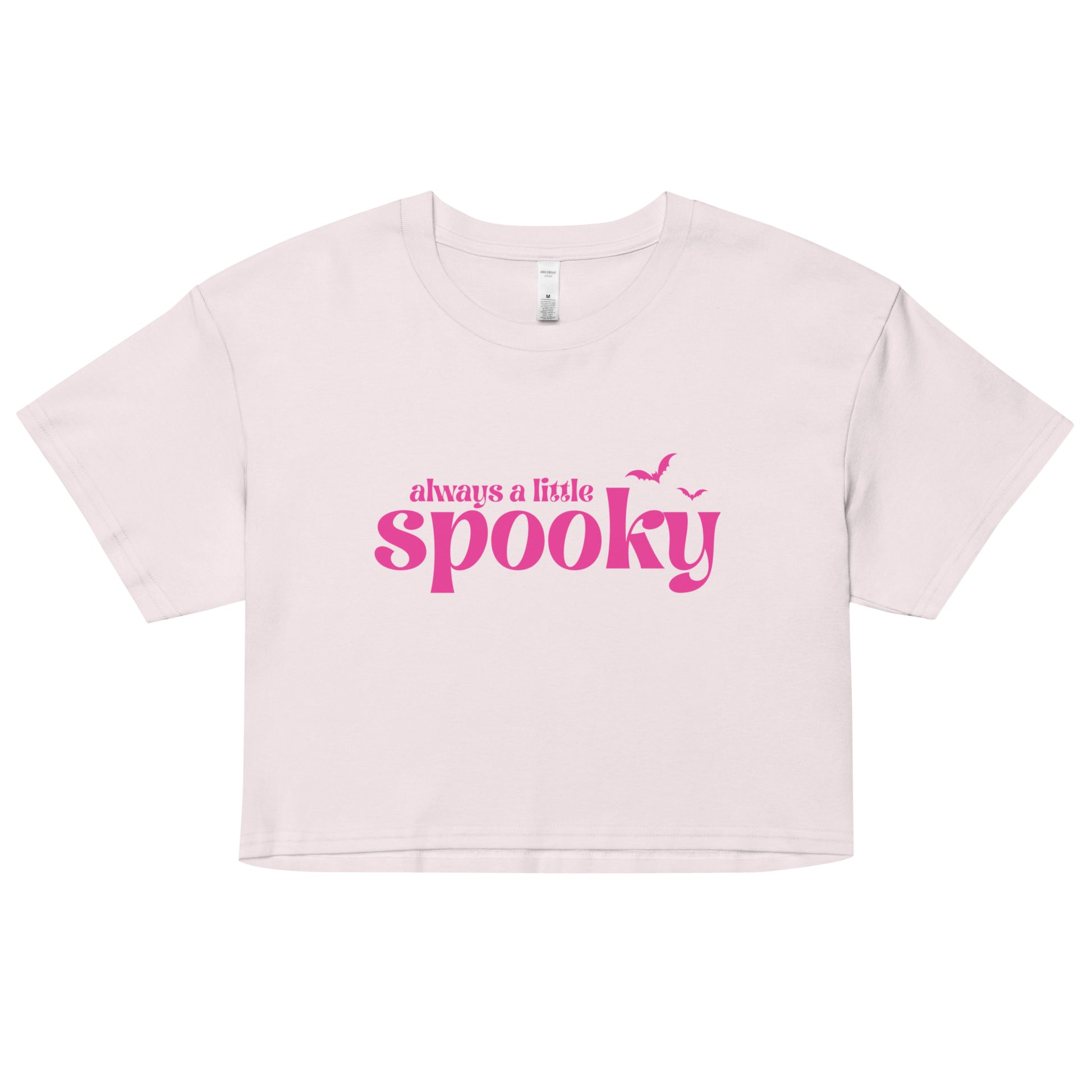A barely-pink, cropped t-shirt that says "always a little spooky" in a bright pink trendy font