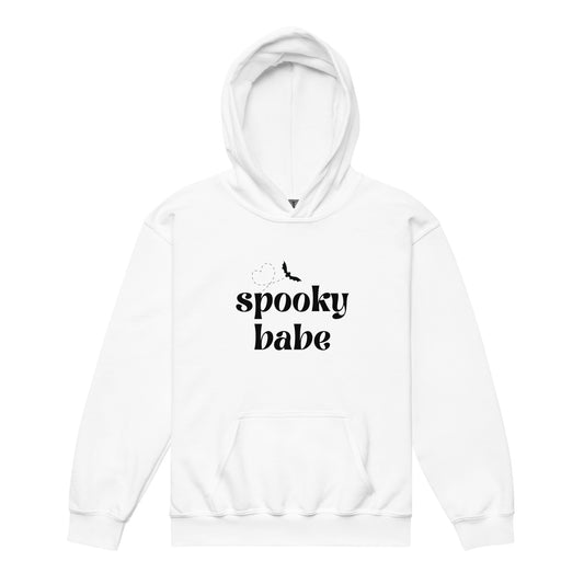 A white kids' hoodie that says "spooky babe" in a black retro font, with a bat flying in a heart-shaped pattern