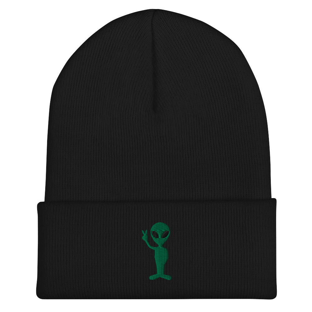 A black cuffed beanie, featuring a green alien making a peace sign with its right arm