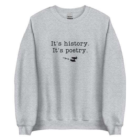 A light gray crewneck sweatshirt with the famous quote from the novel The Catcher in the Rye, "It's history, it's poetry" written in black typewriter-style letters, and a small silhouette of ducks underneath.