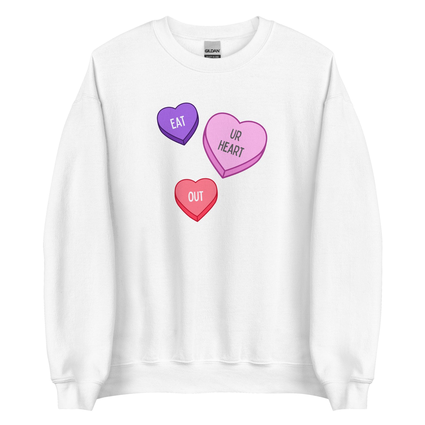 A white crewneck sweatshirt featuring a purple, a pink, and a red candy heart. Together, the candy hearts say "eat ur heart out."